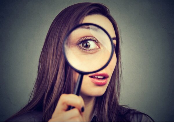 A woman with a magnifying glass.