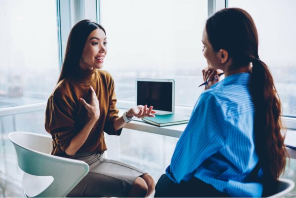Two women speaking.