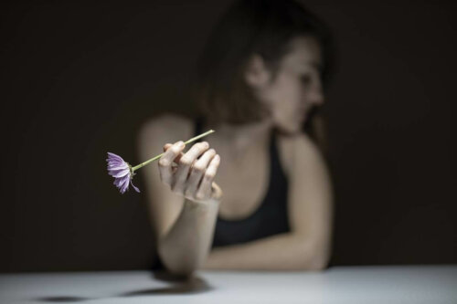 A woman holding a flower.