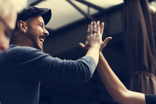 Two people high-fiving each other.