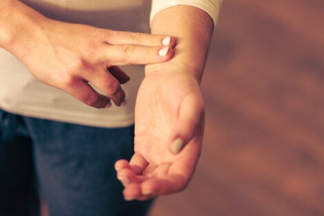A woman checking her pulse.