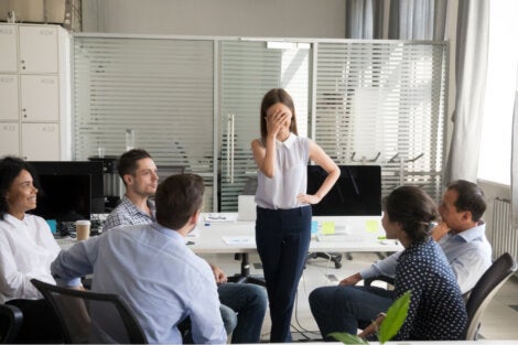 An embarassed woman in front of her coworkers.