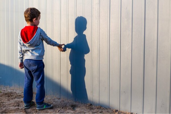 A boy with his shadow.