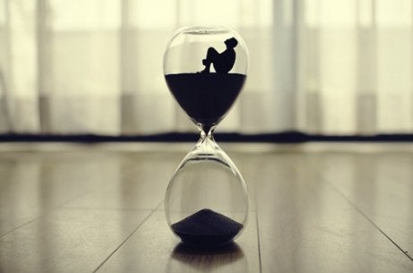 A man sitting inside an hourglass.