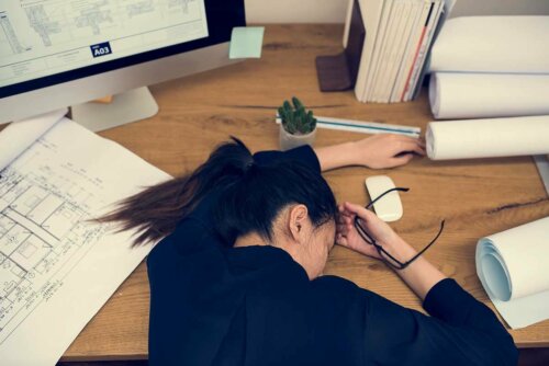 A woman sleeping on her desk.