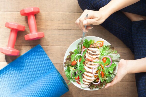 A person holding a salad.