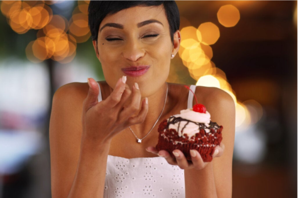 A woman eating a cake.