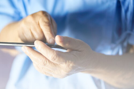 A medic using a mobile device suggesting mobile apps may help those affected by Alzheimers.