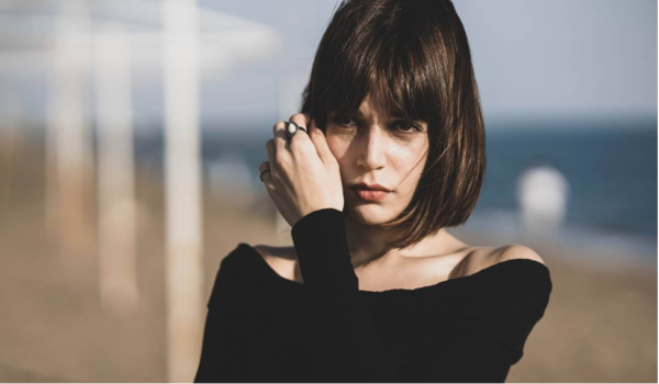 A woman looking thoughtful.
