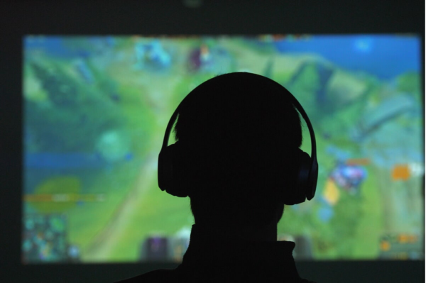 A silhouetted head wearing headphones.