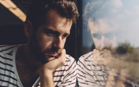 A man looking out the window at the scenery.