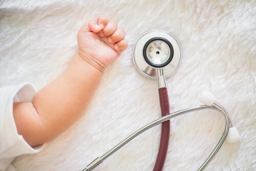 A baby with a medical instrument.