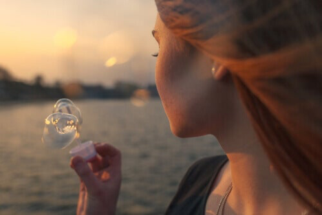 A woman blowing bubbles.
