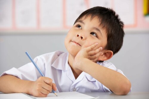 A boy in class thinking.