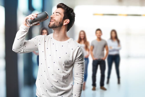 A man drinking an energy drink.