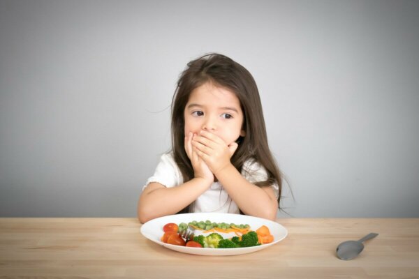 A child covering their mouth.