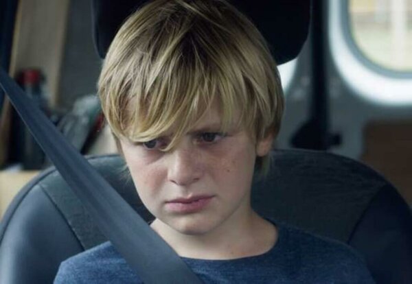 A teenager in a car.