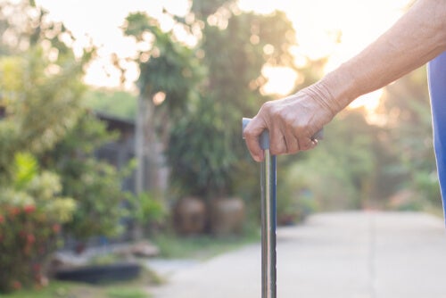 An old person holding a cane.