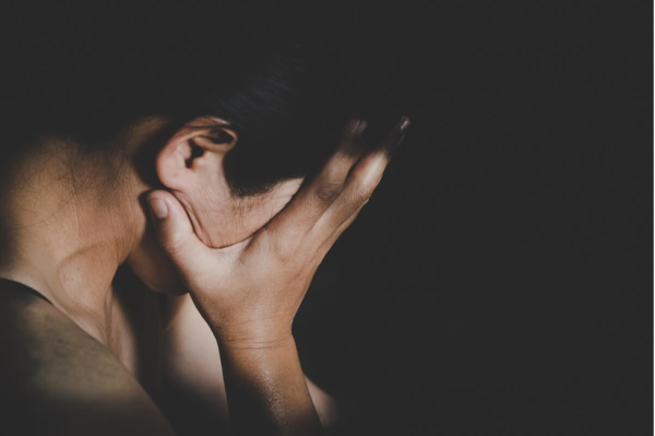A man with his head in his hands.