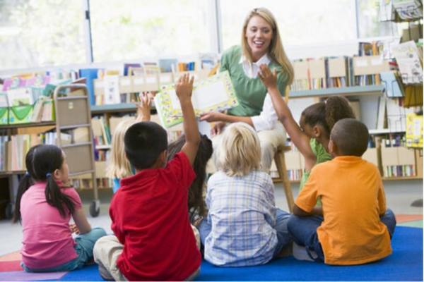 Young children with their teacher.