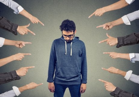 A bunch of people pointing at one guy.