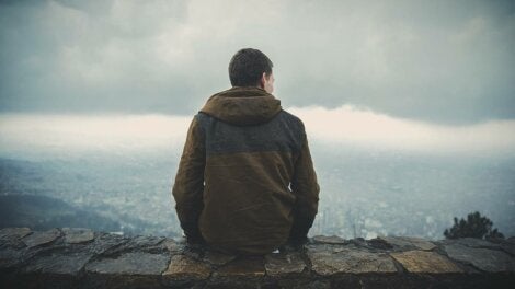 A man sitting on a mountain.
