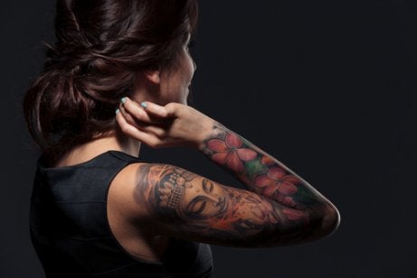 A woman showing her arm tattoos.