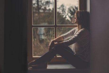 A woman sitting in a window.