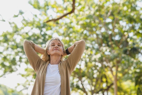An older woman enjoying how nature helps relieve your stress.