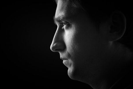 A black and white profile of a man.