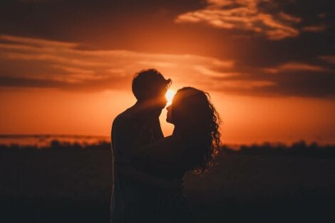 A couple standing together at sunset.