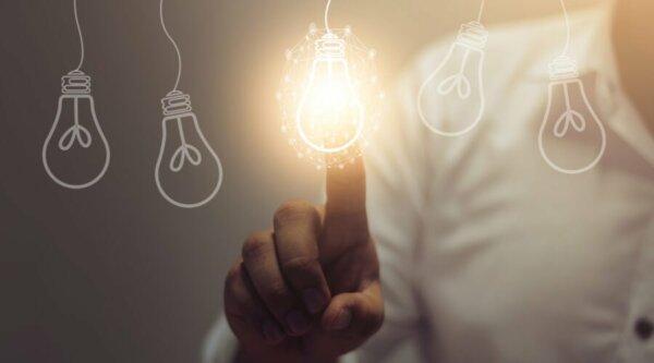 A finger on a lightbulb.