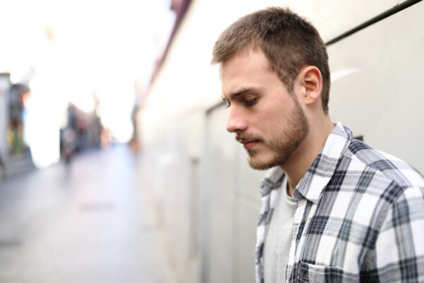 A sad man looking down.