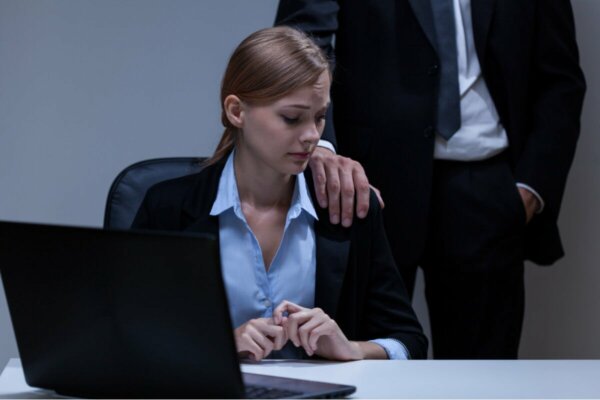 A scared employee and her abuser.