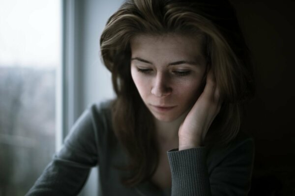 A woman looking worried who doesn't know how to feel.