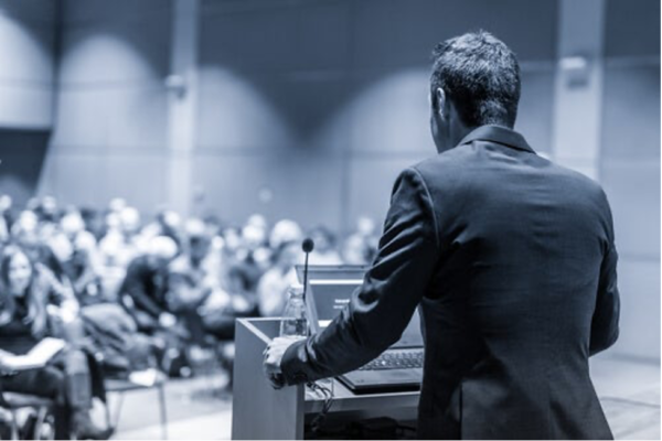 A man speaking to an audience.