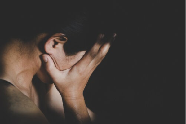 A man with his head in his hands.