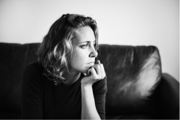 A woman looking worried, perhaps having obsessive thoughts.