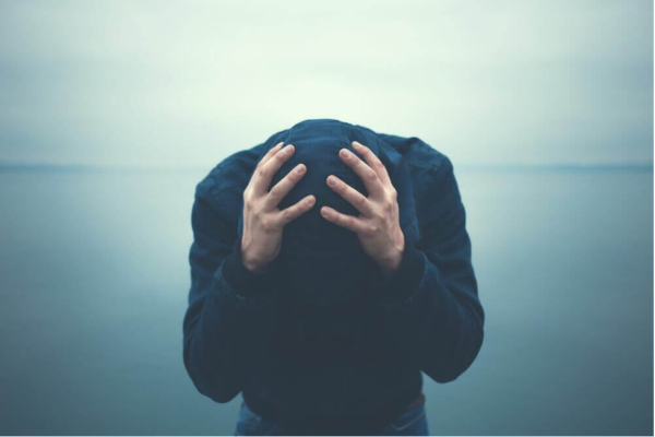 A man with his head in his hands.