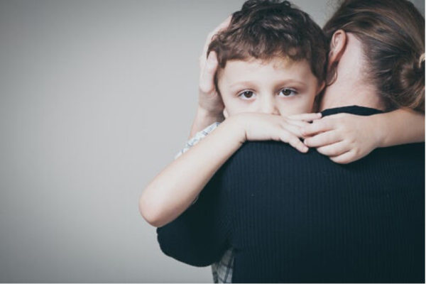 A child being held by a woman.