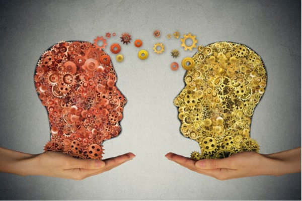 Two twin heads transferring thoughts, implying telepathy between twins.