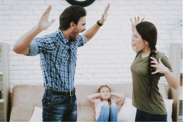 A couple shouting at each other in front of their child.