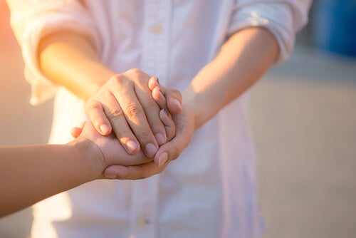 Two people holding hands.
