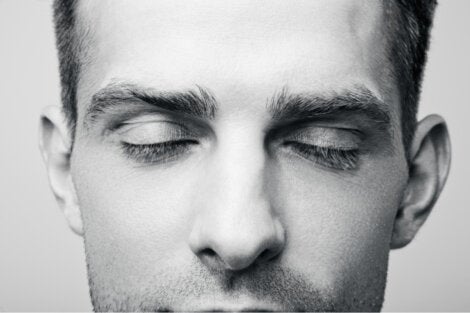 A close up of a guy who is daydreaming.