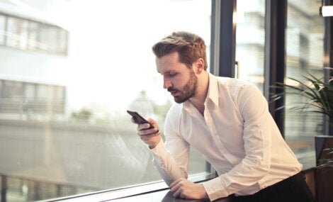 A guy looking down at his phone.