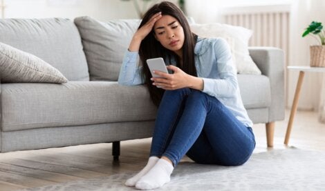 An anxious woman on her phone.