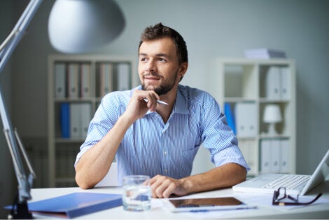 A man thinking at his desk.