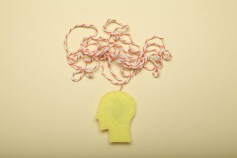 A cutout of a head with a string illustrating thought.