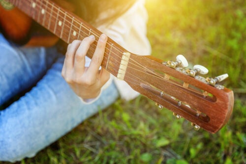 Someone playing the guitar.
