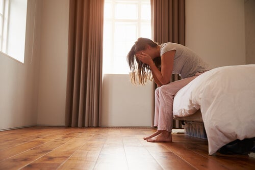 A woman sitting on a bed.